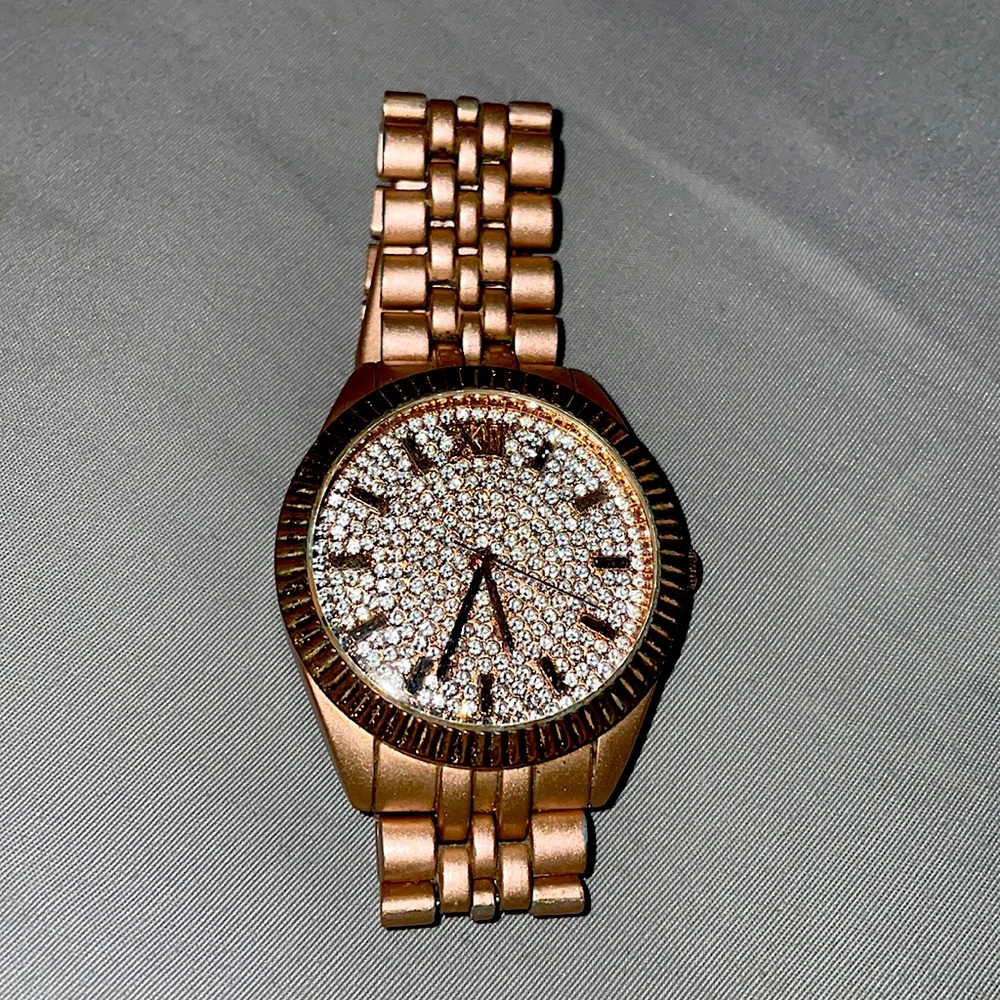 A rose gold sparkles stainless steel watch